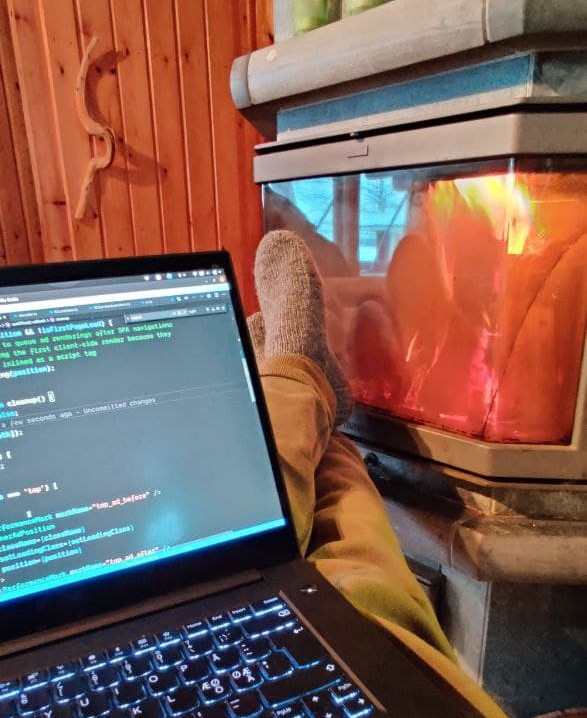 Me on my laptop in front of a fireplace